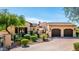 Charming home featuring a brick driveway, a well-manicured lawn and lovely desert landscaping at 18886 N 101St Way, Scottsdale, AZ 85255