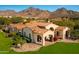 Stunning exterior of a home with a tile roof, lush landscaping, and picturesque mountain views at 18886 N 101St Way, Scottsdale, AZ 85255
