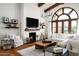 Beautiful living room with a large window, comfortable seating and a cozy fireplace at 18886 N 101St Way, Scottsdale, AZ 85255