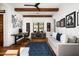 Stylish living room with exposed beam ceiling, a comfortable couch, and elegant decor at 18886 N 101St Way, Scottsdale, AZ 85255