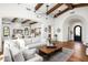 Bright and airy living room with beamed ceilings and a large comfortable sectional sofa at 18886 N 101St Way, Scottsdale, AZ 85255