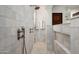 Elegant tiled shower with a rain showerhead, handheld sprayer, and built-in niche at 18886 N 101St Way, Scottsdale, AZ 85255