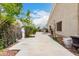 Outdoor patio with manicured landscaping, a decorative statue, and comfortable swing at 1954 E Vista Dr, Phoenix, AZ 85022