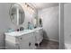 Well-lit bathroom featuring double vanities, modern fixtures, and decorative mirrors at 1954 E Vista Dr, Phoenix, AZ 85022