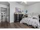 Cozy bedroom with hardwood floors, vintage furniture, and ample closet space at 1954 E Vista Dr, Phoenix, AZ 85022