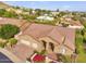 Aerial view of a home featuring a well maintained roof, landscaping, and attached two-car garage at 1954 E Vista Dr, Phoenix, AZ 85022