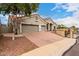 Exterior showcases a 2-car garage, driveway, stucco walls, and tile roof on a sunny day at 1954 E Vista Dr, Phoenix, AZ 85022