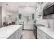 Bright kitchen features white cabinets, stainless steel appliances, marble countertops, and tile flooring at 1954 E Vista Dr, Phoenix, AZ 85022