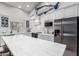 Bright kitchen features white cabinets, stainless steel appliances, marble countertops, and marlin statue at 1954 E Vista Dr, Phoenix, AZ 85022