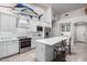 Bright, modern kitchen with stainless steel appliances, an island with barstool seating, and decor at 1954 E Vista Dr, Phoenix, AZ 85022