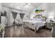 Spacious main bedroom with decorative bed frame, wood floors, and ample natural light at 1954 E Vista Dr, Phoenix, AZ 85022