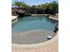 Backyard pool featuring rock waterfall, mature trees, and desert landscaping at 1954 E Vista Dr, Phoenix, AZ 85022