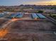 Aerial view of horse property with stalls, riding arenas and mountain views at 20497 E Appaloosa Dr, Queen Creek, AZ 85142