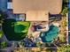 Aerial view of backyard featuring a sparkling pool, putting green, and outdoor patio, ideal for leisure at 20497 E Appaloosa Dr, Queen Creek, AZ 85142