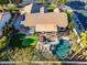 Birds eye view of a backyard with a pool, golf putting green, beautiful landscaping, and a covered patio at 20497 E Appaloosa Dr, Queen Creek, AZ 85142