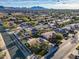 An aerial view of a suburban neighborhood with mountain views, featuring manicured lawns and mature trees at 20497 E Appaloosa Dr, Queen Creek, AZ 85142
