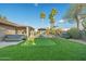 Beautiful backyard oasis with artificial turf putting green, patio, and desert landscaping at 20497 E Appaloosa Dr, Queen Creek, AZ 85142