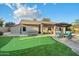 Beautiful backyard oasis with artificial turf putting green, patio, hot tub, and desert landscaping at 20497 E Appaloosa Dr, Queen Creek, AZ 85142