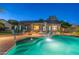 Enjoy a backyard oasis with a sparkling pool, outdoor dining, and manicured landscaping perfect for outdoor relaxation at 20497 E Appaloosa Dr, Queen Creek, AZ 85142
