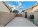 A concrete driveway with a wood gate separating neighbors in the backyard at 20497 E Appaloosa Dr, Queen Creek, AZ 85142
