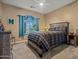 Comfortable bedroom with a wooden bed frame, ceiling fan, and window with curtains at 20497 E Appaloosa Dr, Queen Creek, AZ 85142