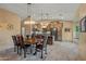 Dining space with a large wood table, hanging lights, and connection to the kitchen at 20497 E Appaloosa Dr, Queen Creek, AZ 85142