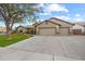 Charming single-story home with a three-car garage, well-manicured lawn, and mature palm trees at 20497 E Appaloosa Dr, Queen Creek, AZ 85142