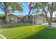 Charming single-story home with a three-car garage, flag pole, and well-manicured lawn at 20497 E Appaloosa Dr, Queen Creek, AZ 85142