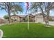 Attractive home with lush green lawn, mature trees, and a visible American flag at 20497 E Appaloosa Dr, Queen Creek, AZ 85142