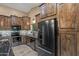 Rustic kitchen featuring wood cabinets, stainless steel appliances, and decorative tile backsplash at 20497 E Appaloosa Dr, Queen Creek, AZ 85142