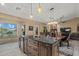 Modern kitchen island featuring dark wood cabinets and black marble countertop at 20497 E Appaloosa Dr, Queen Creek, AZ 85142