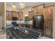 Spacious kitchen featuring custom wood cabinetry, a large island, granite countertops, and stainless steel appliances at 20497 E Appaloosa Dr, Queen Creek, AZ 85142