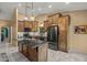 Spacious kitchen featuring custom wood cabinetry, a large island, granite countertops, and stainless steel appliances at 20497 E Appaloosa Dr, Queen Creek, AZ 85142