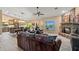 Open-concept living space with stone fireplace, leather seating, and seamless transition to the kitchen at 20497 E Appaloosa Dr, Queen Creek, AZ 85142