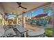 Inviting covered patio with ceiling fans, comfortable seating, and views of the sparkling pool and lush landscaping at 20497 E Appaloosa Dr, Queen Creek, AZ 85142