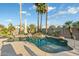 Inviting pool featuring lush landscaping, rock waterfall, and shimmering water, perfect for relaxing and entertaining at 20497 E Appaloosa Dr, Queen Creek, AZ 85142