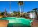 A backyard swimming pool features rock accents and mature landscaping at 20497 E Appaloosa Dr, Queen Creek, AZ 85142