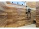 Modern shower featuring wood-look tile, stylish black fixtures, and a window for natural light at 20497 E Appaloosa Dr, Queen Creek, AZ 85142