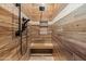 Modern shower with wood-look tile, built-in bench, and stylish fixtures at 20497 E Appaloosa Dr, Queen Creek, AZ 85142