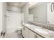 Bright bathroom with double sinks, granite counters, large mirror and shower over tub at 25339 N 19Th Ln, Phoenix, AZ 85085