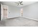 Spacious bedroom with plush carpeting, ceiling fan, and walk in closet entrance at 25339 N 19Th Ln, Phoenix, AZ 85085