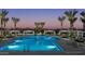 Inviting community pool featuring palm trees, cabanas, and comfortable lounge chairs at 25339 N 19Th Ln, Phoenix, AZ 85085