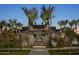 Community pool entrance at twilight with palm trees and inviting ambiance at 25339 N 19Th Ln, Phoenix, AZ 85085