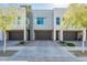Contemporary townhome exterior featuring stone accents, private garages, and manicured landscaping at 25339 N 19Th Ln, Phoenix, AZ 85085