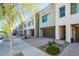 Row of stylish townhouses featuring attached garages and low-maintenance desert landscaping at 25339 N 19Th Ln, Phoenix, AZ 85085