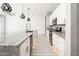 Modern kitchen with white cabinets, a spacious island, and pendant lighting at 25339 N 19Th Ln, Phoenix, AZ 85085