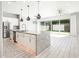 Open-concept kitchen featuring a large island, modern appliances, and sliding glass doors to the backyard at 25339 N 19Th Ln, Phoenix, AZ 85085