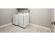 Bright laundry room with tiled floor and white appliances including washer and dryer at 25339 N 19Th Ln, Phoenix, AZ 85085