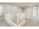 Carpeted upstairs loft area with white railing and recessed lighting at 25339 N 19Th Ln, Phoenix, AZ 85085