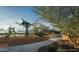 Community playground with play structure featuring slides, rope bridge, and sun shade at 25339 N 19Th Ln, Phoenix, AZ 85085